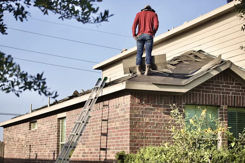 Professional roofer working on a residential roof in Wallin Woods